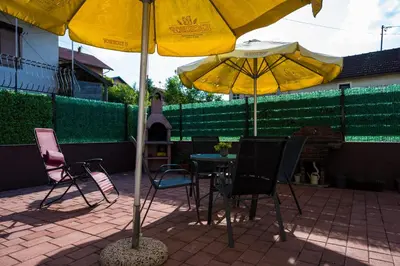 a table and chairs under an umbrella on a patio at Gajic & Milini in Banja Luka