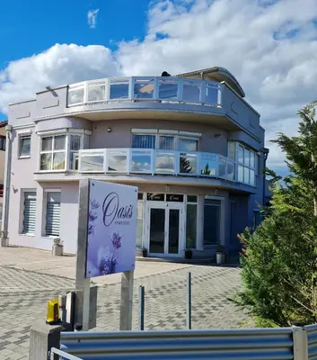 a building with a sign in front of it at Oasis in Bihać