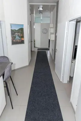 a hallway with a long carpet on the floor at Oasis in Bihać