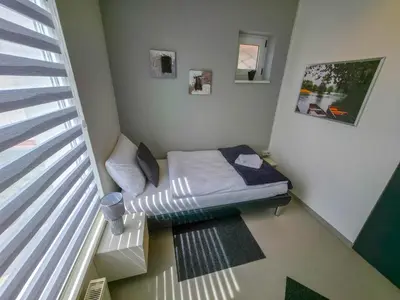 a small room with a bed and a window at Oasis in Bihać