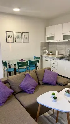 a living room with a couch and a table at Apartman Dina in Sanski most