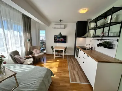 a room with a kitchen and a living room at Studio Mint&White Borik in Banja Luka