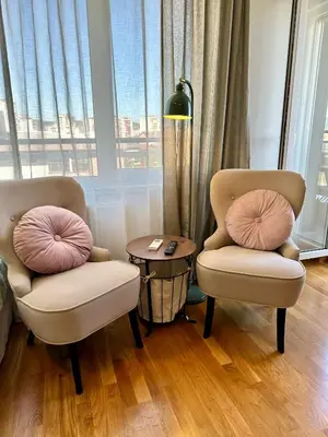 two chairs and a table in a room with a window at Studio Mint&White Borik in Banja Luka