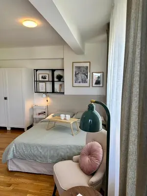 a bedroom with a bed and a table and a chair at Studio Mint&White Borik in Banja Luka