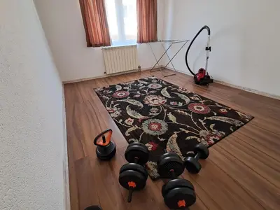 a room with a rug and shoes on the floor at Boema in Ivišovo Greblje