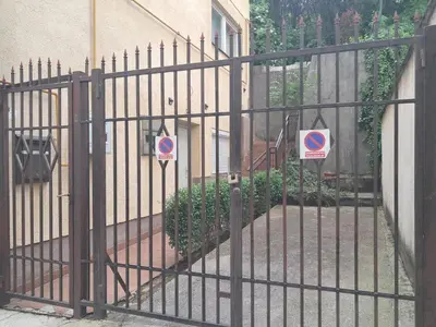 an iron gate with two no parking signs on it at Boema in Ivišovo Greblje