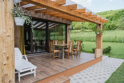 a wooden deck with a table and chairs at Mali Wimbledon in Visoko