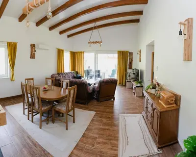 a living room with a table and a couch at Mali Wimbledon in Visoko