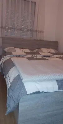 a group of four beds in a room at Osmica Doboj in Doboj