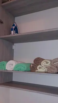a shelf with several different colored towels on it at Osmica Doboj in Doboj