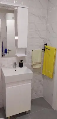 a bathroom with a white sink and a yellow towel at Osmica Doboj in Doboj