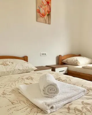 a bedroom with two beds with towels on them at Apartman Lucija in Rumboci