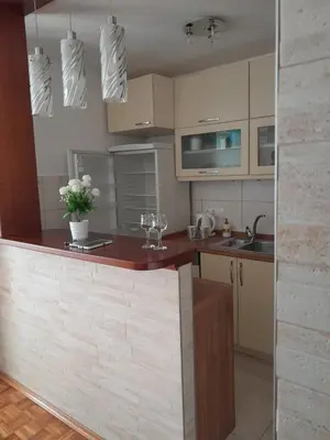 a kitchen with a counter with flowers on it at Apartman Borik Banja Luka in Banja Luka