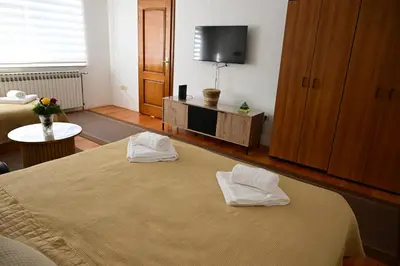 a hotel room with two white towels on a bed at Apartman Nur in Bihać