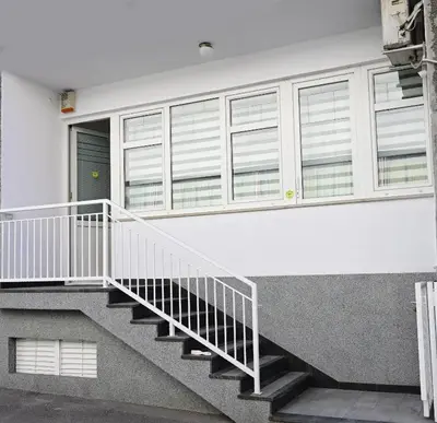 a staircase in a building with windows at Apartman Nur in Bihać