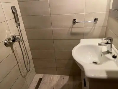 a bathroom with a sink and a shower at Vikendica Mati in Kupres