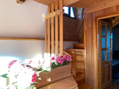 a room with stairs and flowers on a table at Vikendica Mati in Kupres