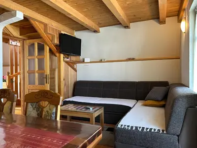 a living room with a couch and a table at Vikendica Mati in Kupres