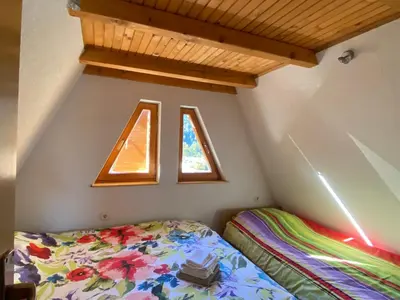 a small room with a bed and a window at Vikendica Mati in Kupres
