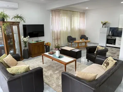 a living room with couches and a coffee table at Apartman Jasmina in Pokoj