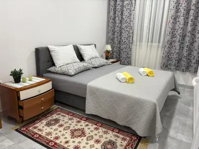 a bedroom with two beds with towels on them at Apartman Jasmina in Pokoj
