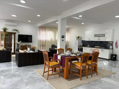 a kitchen and living room with a table and chairs at Apartman Jasmina in Pokoj