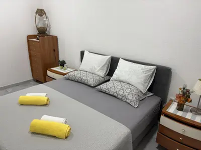a bedroom with a bed with two pillows at Apartman Jasmina in Pokoj