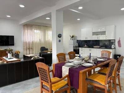 a kitchen and dining room with a table and chairs at Apartman Jasmina in Pokoj