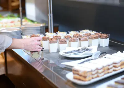 a buffet line with a bunch of food on at Hotel Jelena in Banja Luka