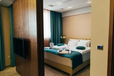 a hotel room with a bed with towels on it at Hotel Jelena in Banja Luka