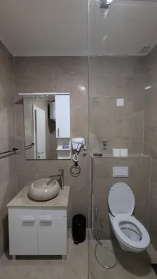 a bathroom with a toilet and a sink and a mirror at Apartment SKY in Travnik