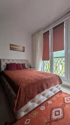 a bedroom with a bed and a large window at Apartment SKY in Travnik