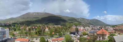 a view of a city with mountains in the background at Apartment SKY in Travnik