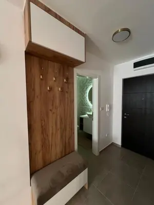 a room with a wooden door and a bathroom at Elita Apartmani in Ivišovo Greblje