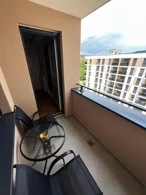 a balcony with a table and chairs on a building at Elita Apartmani in Ivišovo Greblje