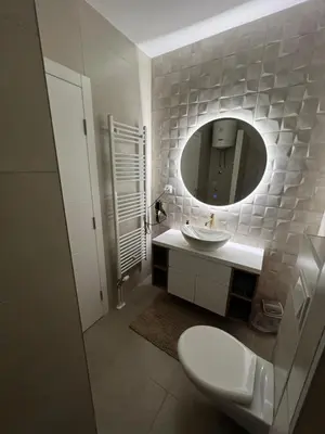 a bathroom with a sink and a mirror at Elita Apartmani in Ivišovo Greblje