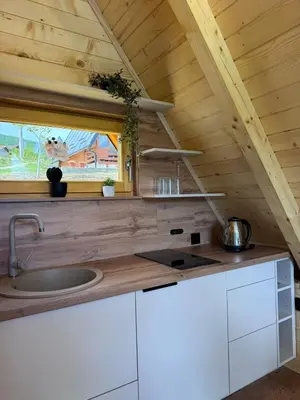 a kitchen with a sink and a window in a cabin at Cottage Lana 2 in Jajce