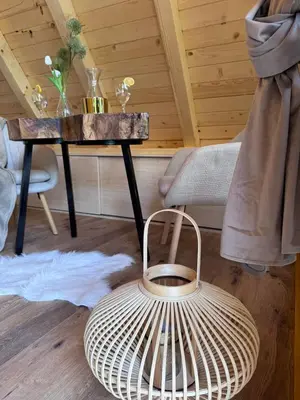 a room with a table with a rattan basket next to a table with at Cottage Lana 2 in Jajce