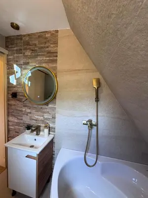 a bathroom with a sink and a tub and a mirror at Cottage Lana 2 in Jajce
