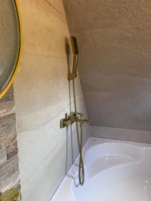 a bath tub with a faucet in a bathroom at Cottage Lana 2 in Jajce