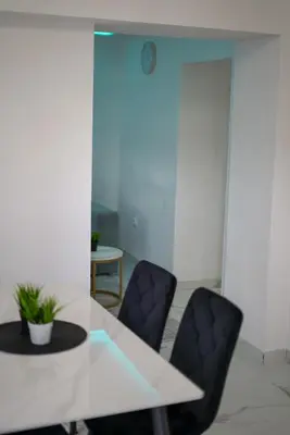 a dining room with a white table and chairs at Apartman Amna in Jajce