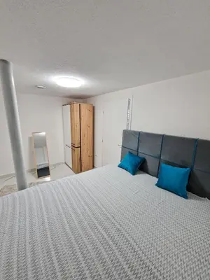 a bedroom with a large bed with blue pillows at Apartman Amna in Jajce