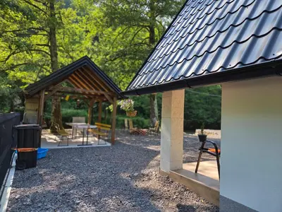 a building with a pavilion with a table and chairs at Villa Tea in Šipovo