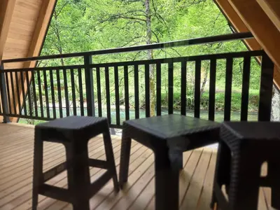 a porch with two chairs and a table and a window at Villa Tea in Šipovo