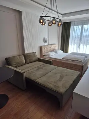 a bedroom with two beds and a couch in it at GRAND LUX view in Banja Luka