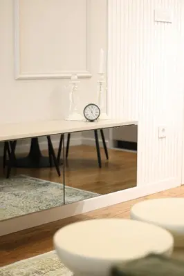 a table with a mirror and a clock on it at GRAND LUX view in Banja Luka