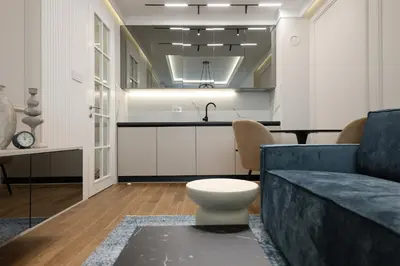 a living room with a couch and a kitchen at GRAND LUX view in Banja Luka
