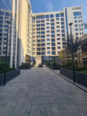 an empty street in front of a large building at GRAND LUX view in Banja Luka