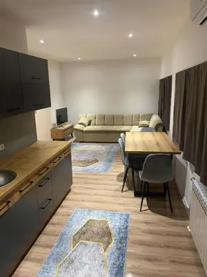 a kitchen and living room with a table and a couch at Marshal 2