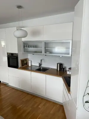 a kitchen with white cabinets and a sink at Apartman Pannonica Centar in Tuzla